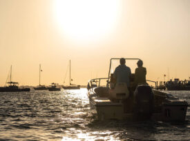 The author and his wife aboard their boat at sunset