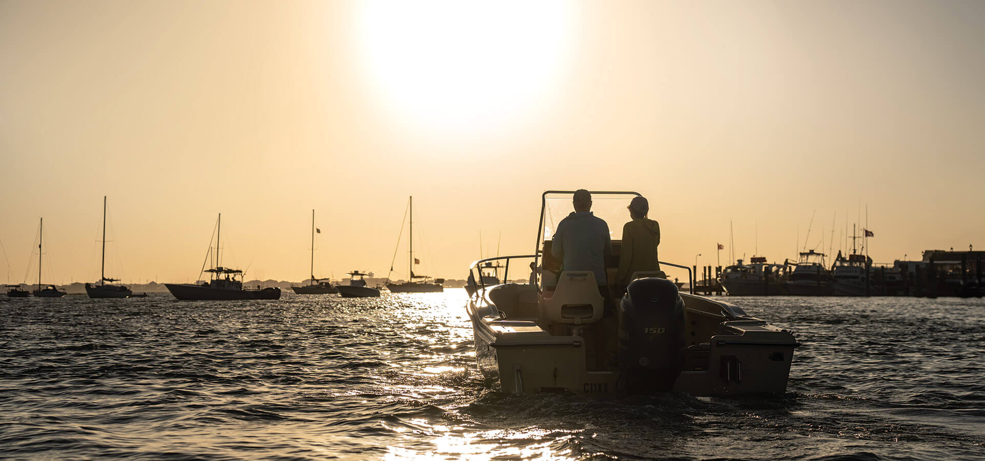 The author and his wife aboard their boat at sunset