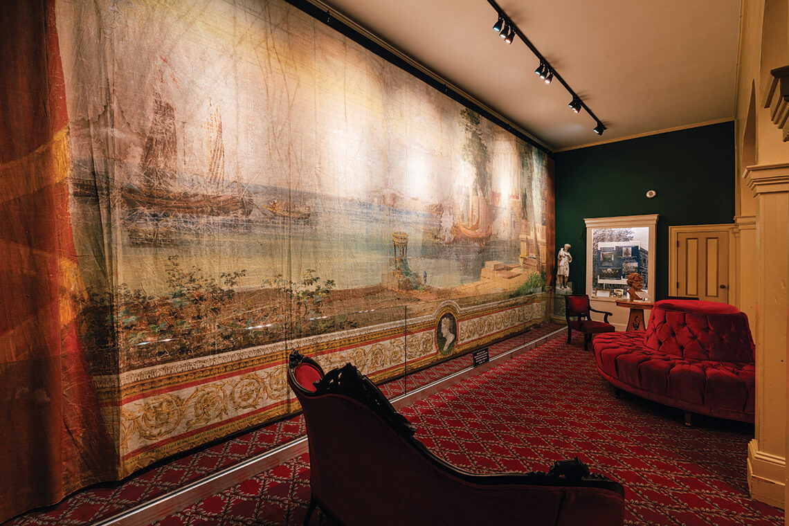 The lobby of Thalian Hall, with the original drop curtain that hung onstage in 1858