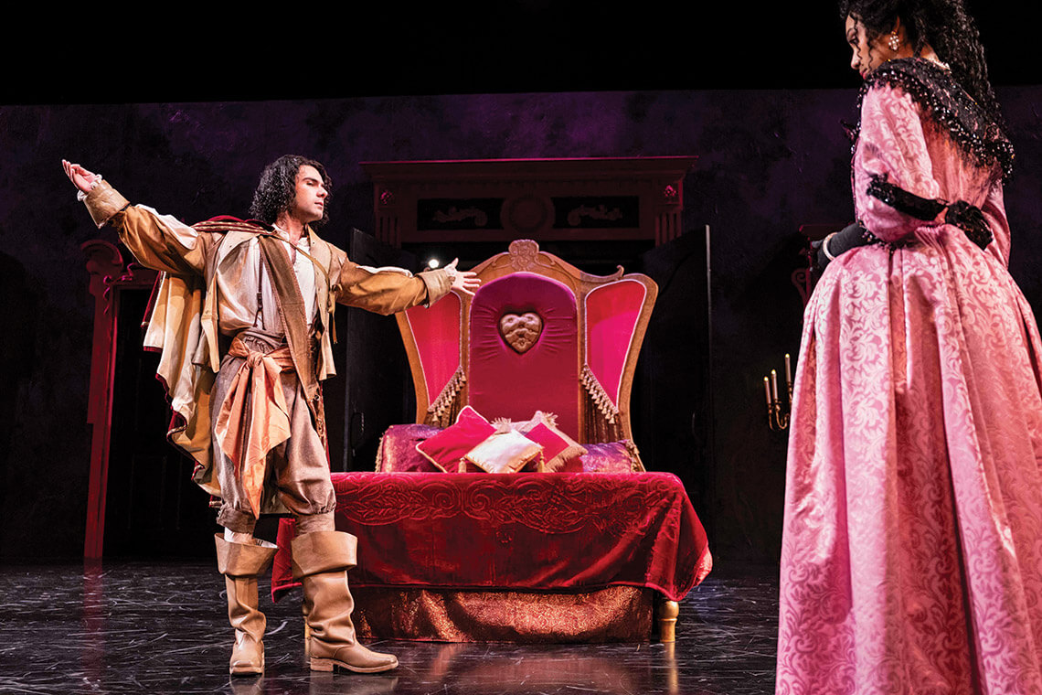 When actors Jack Zubieta Elliott and Abigail Garcia take the stage for The Rover, the set, costumes, and props — like the elaborate bed — complete the scene.