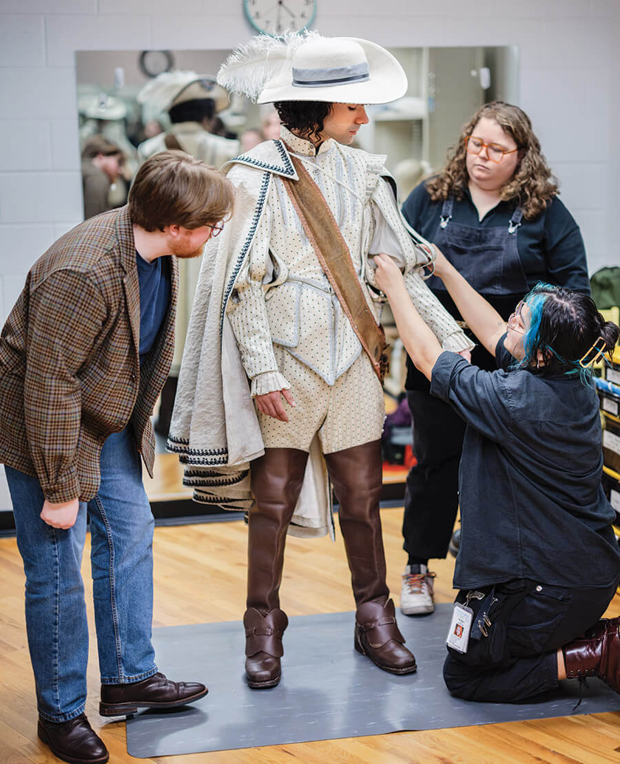 Costume design assistants Teddy McMahon and Maki Niikura help bring costume design to life for actor Jack Zubieta Elliott.