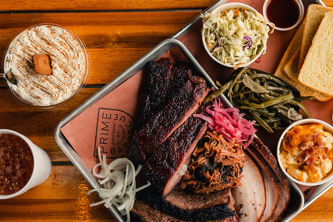 Tray of smoked meat, banana pudding, and iced tea from Prime Barbecue
