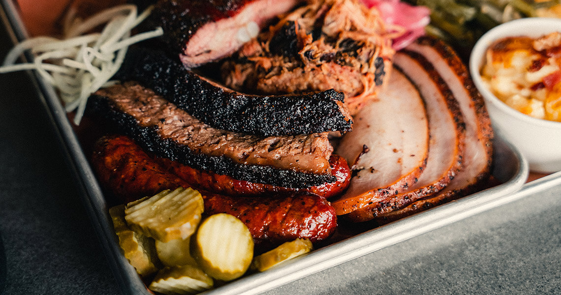 Tray of smoked meats, pickles, and mac 'n' cheese from Prime Barbecue, one of the featured restaurants at the Pinehurst Barbecue Festival