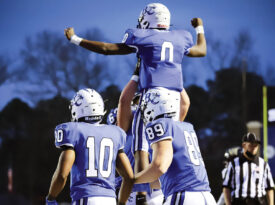 Barton College Football players celebrate a victory.
