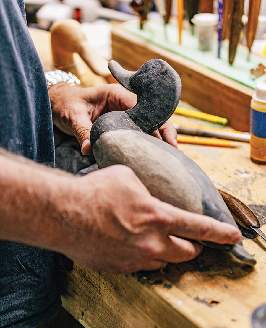Corey Lawrence carving a duck decoy
