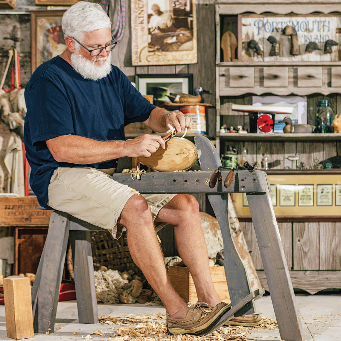 Corey Lawrence carving a duck decoy, a symbol of Down East