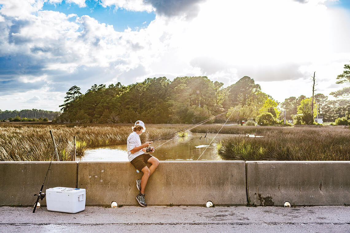 Fishing from a bridge in Otway is one form of solitude in Down East