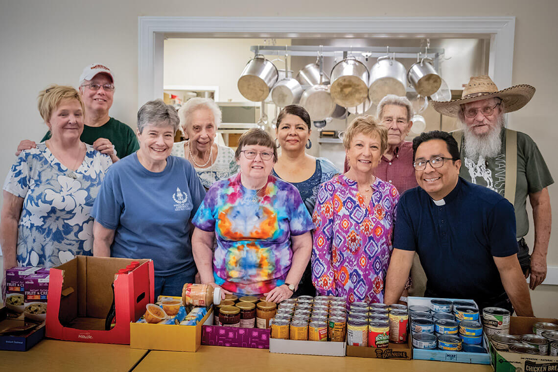 Pastor Llerena and members of the Franklinton United Methodist Church congregation organizing the church's food pantry