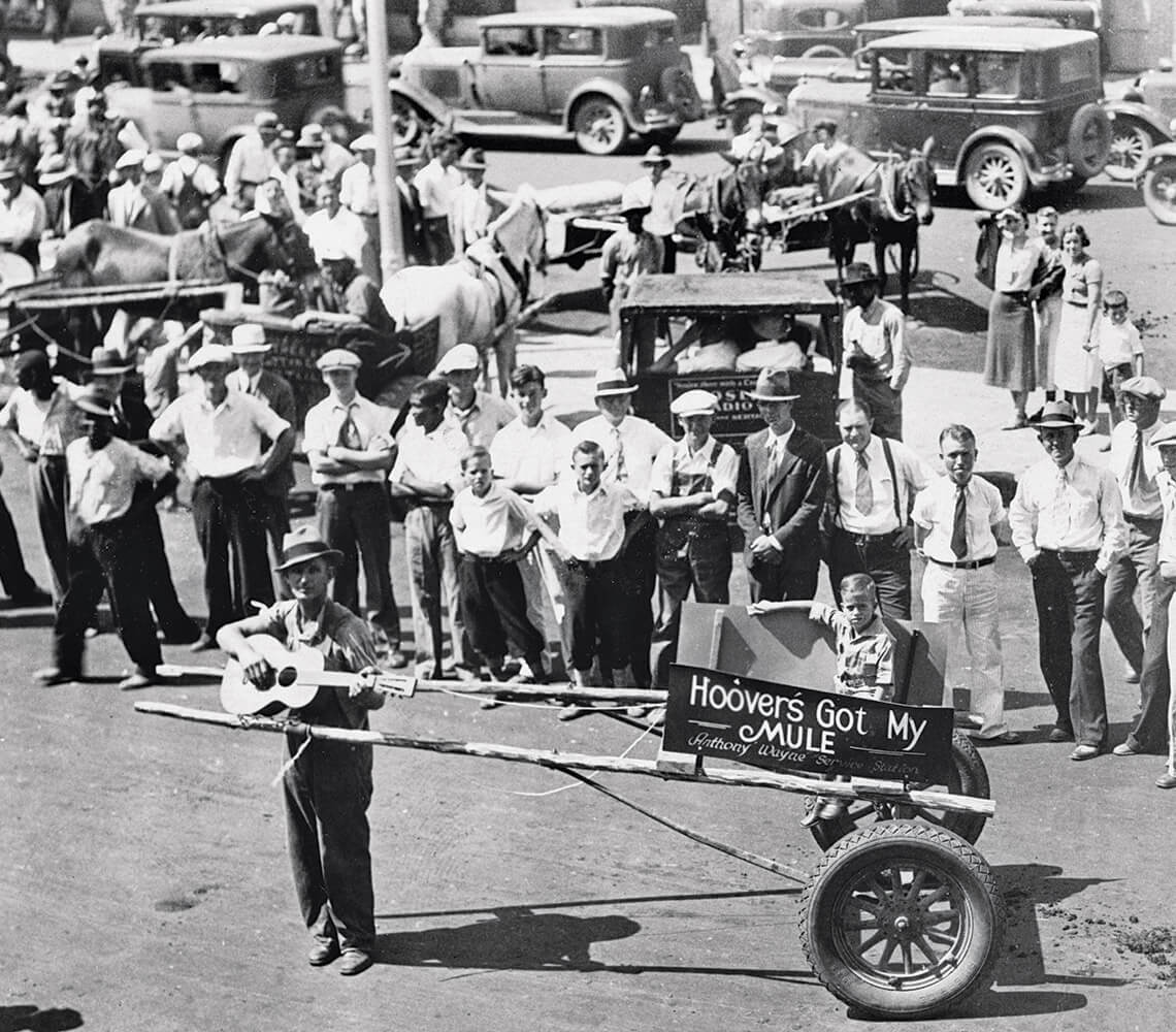 Man pulls Hoover cart carrying a child