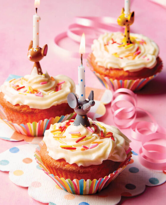 Strawberry cupcakes topped with birthday candles
