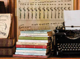 stacks of vintage books, often by local authors, at Blue Moon Books in Canton and the shop’s Royal typewriter, which, like most of the titles, is decades old.