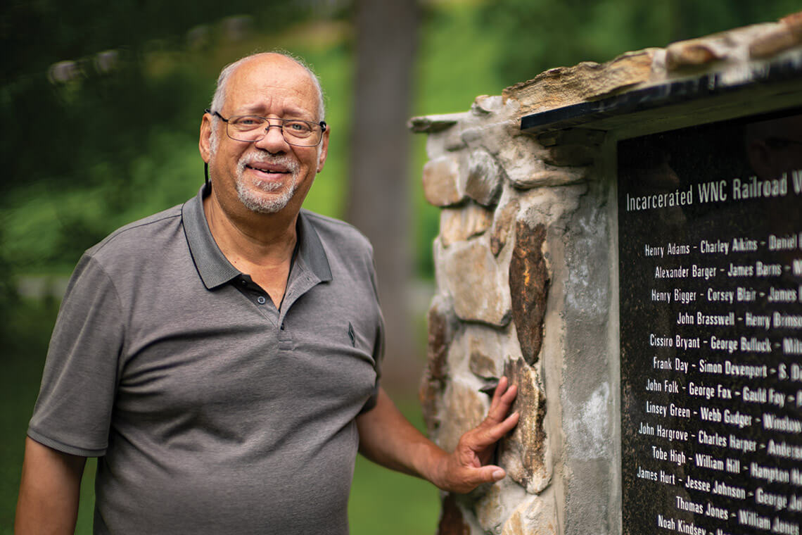 Paul Twitty stands with the RAIL marble memorial at Andrews Geyser
