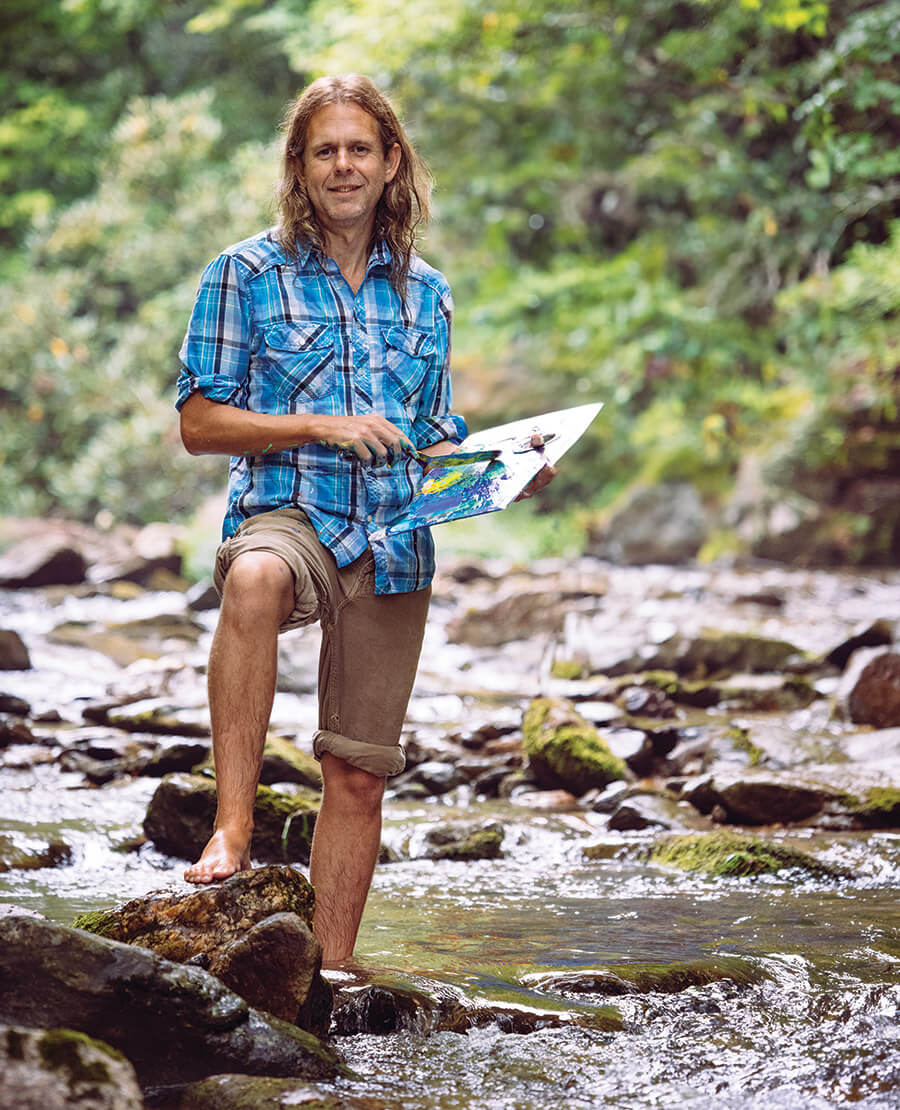 Kent Paulette painting in the river