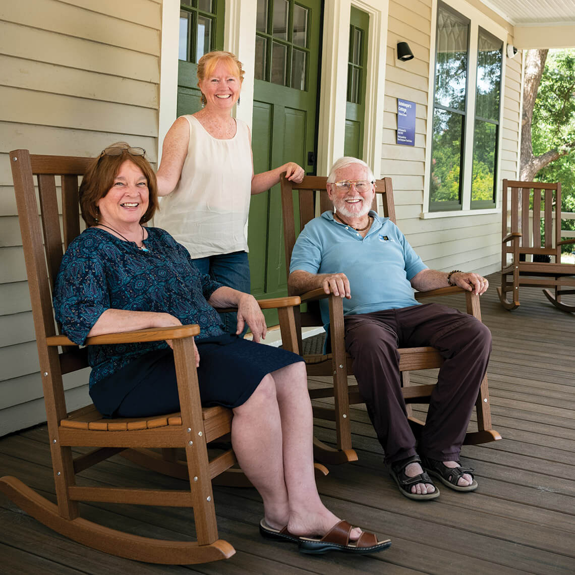 Diana Barefoot, Rebecca L. Withrow, and Glenn Withrow on the porch of the stone house at Dorothea Dix Park