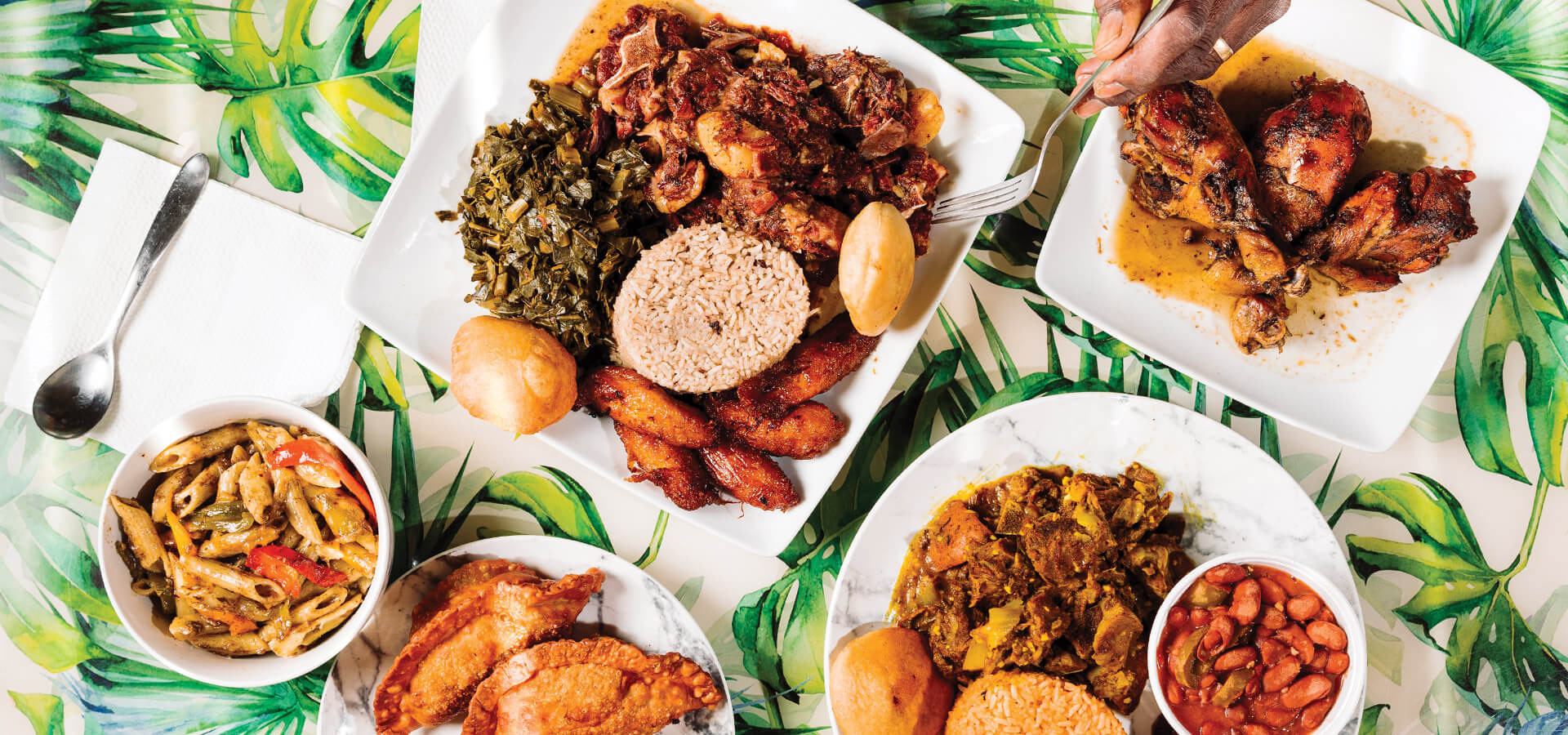 A table full of food from West Indian Kitchen iin Jacksonville, NC