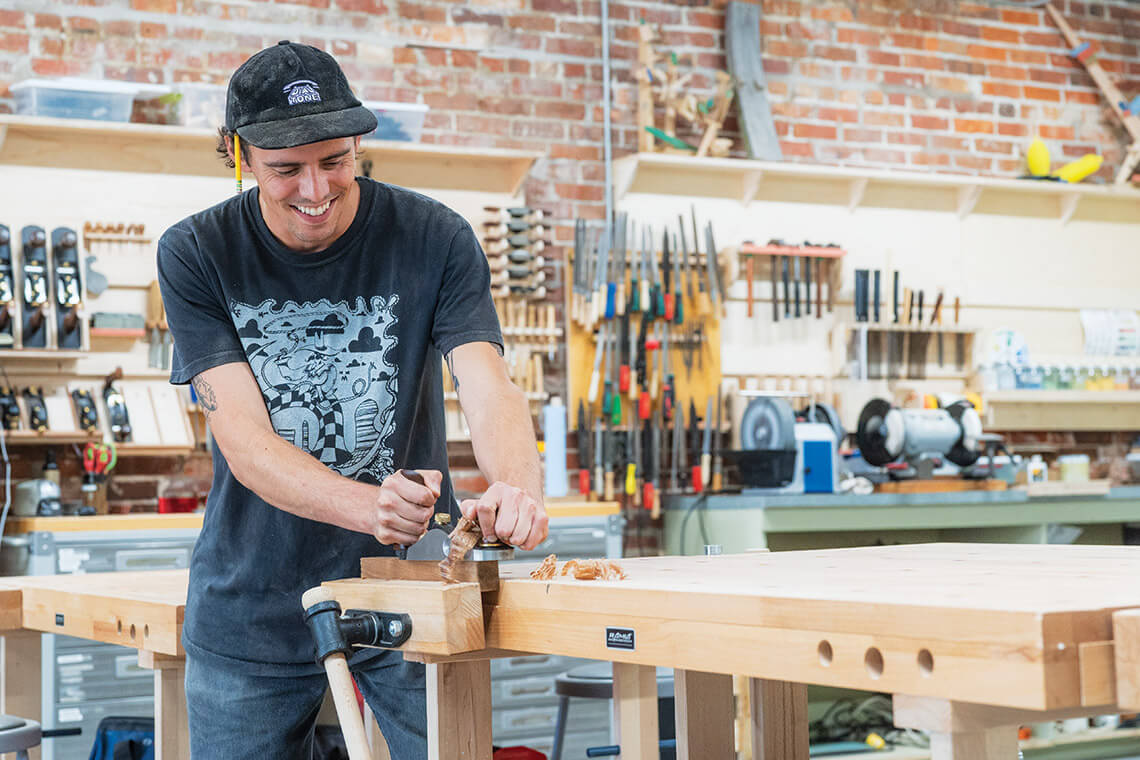 Instructor Ryan Lutz sands a table at Pocosin Arts School of Fine Craft in Columbia. NC