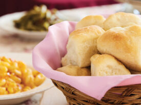 Table set with basket of sourdough rolls and Thanksgiving sides from The Rosebriar.
