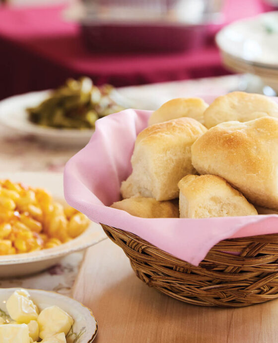 Table set with basket of sourdough rolls and Thanksgiving sides from The Rosebriar.