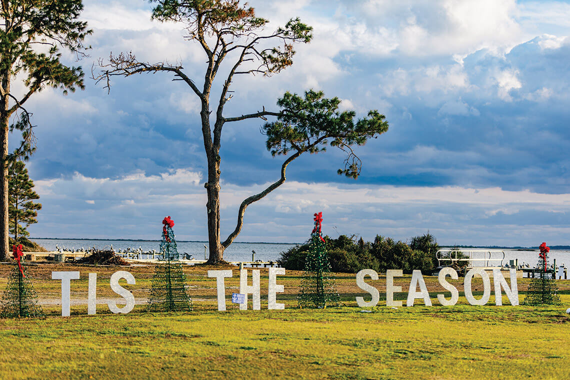 Crab pot Christmas Trees and a sign reading Tis the Season in Harkers Island