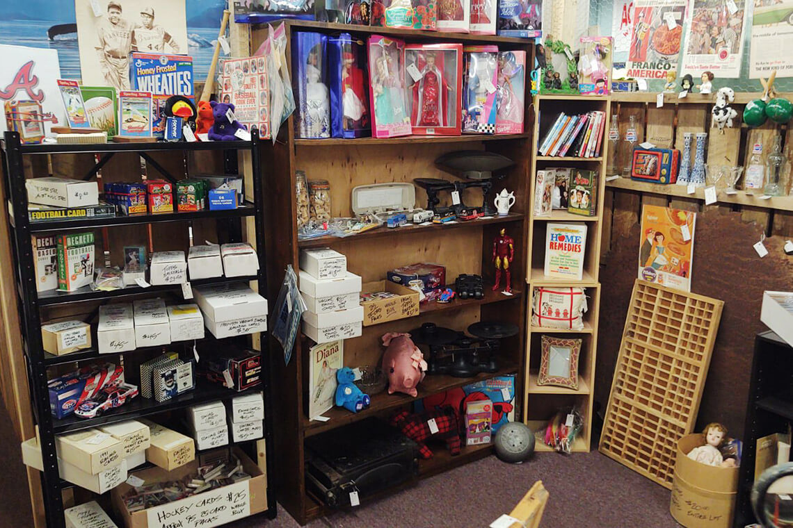 Shelves of vintage toys inside Antiques & Geeks in Asheboro