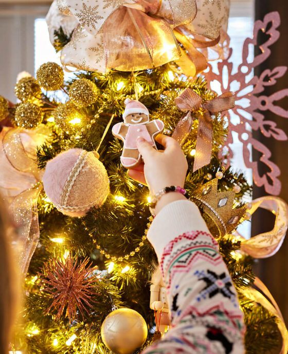 Children decorate the Christmas tree at the Master Mason Cottage at the Masonic Home for Children in Oxford, NC