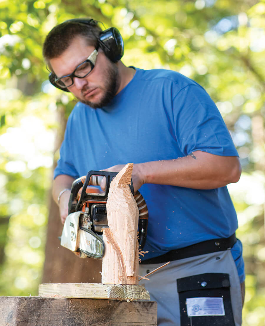 Poplin carves a cardinal figurine