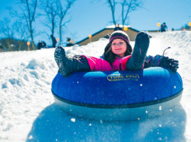 Little girl snowtubing at Beech Mountain ski resort near Boone, NC