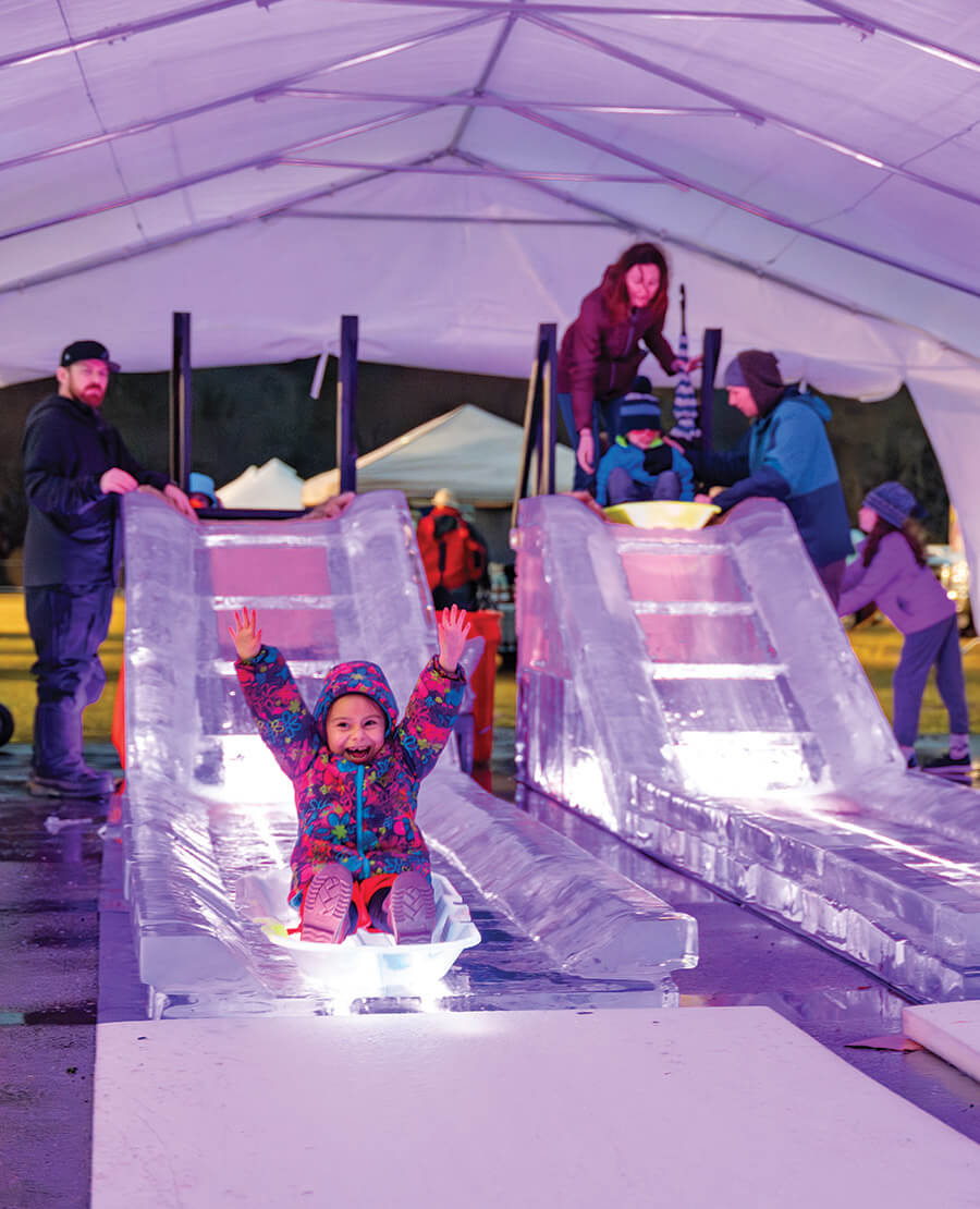 Little girl on a slide made of ice
