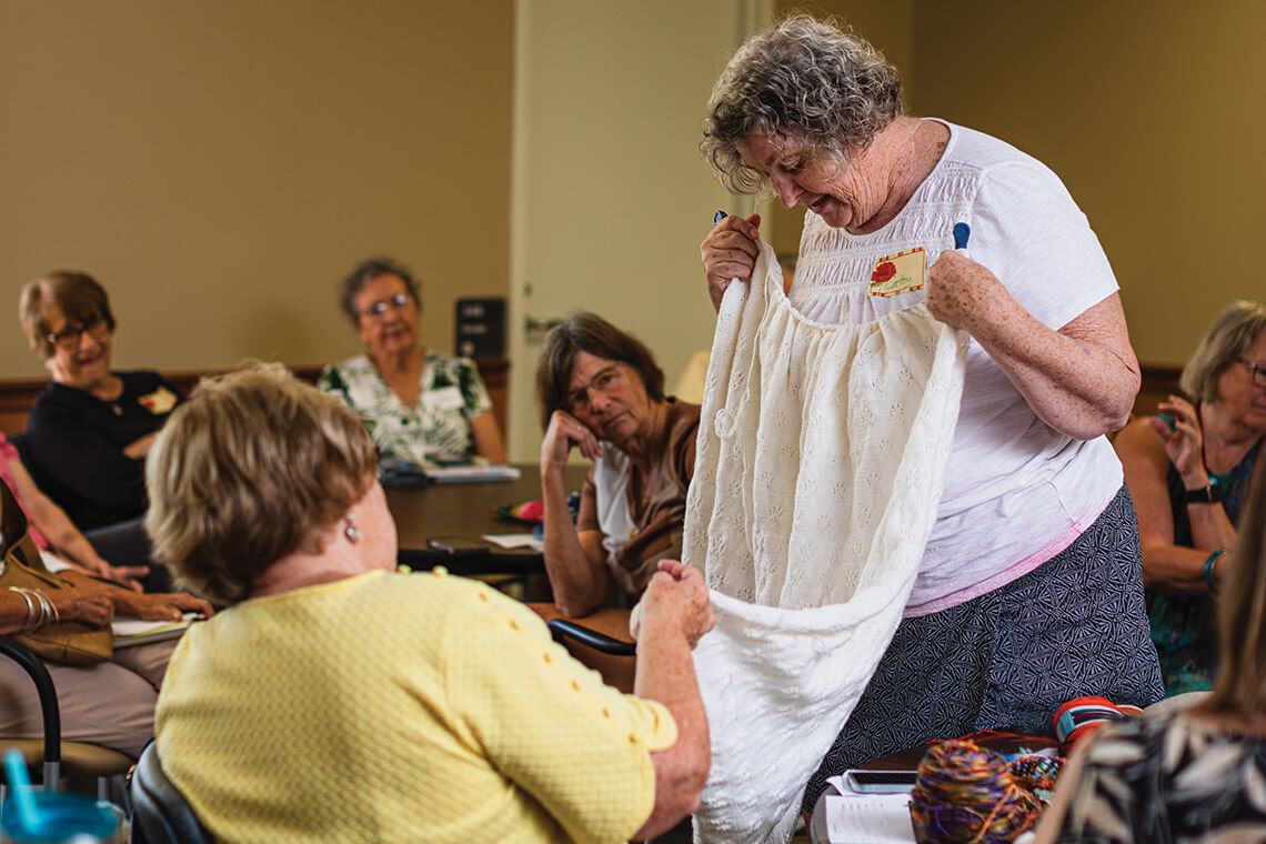 Cathy Coons shows off her completed blanket