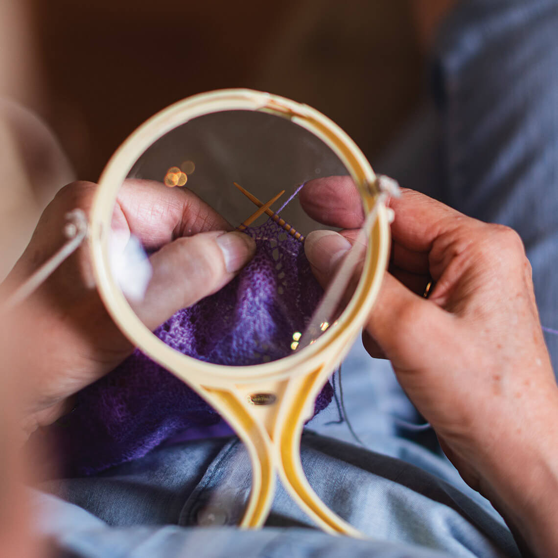 A magnifying glass helps knit delicate, tiny purls. 