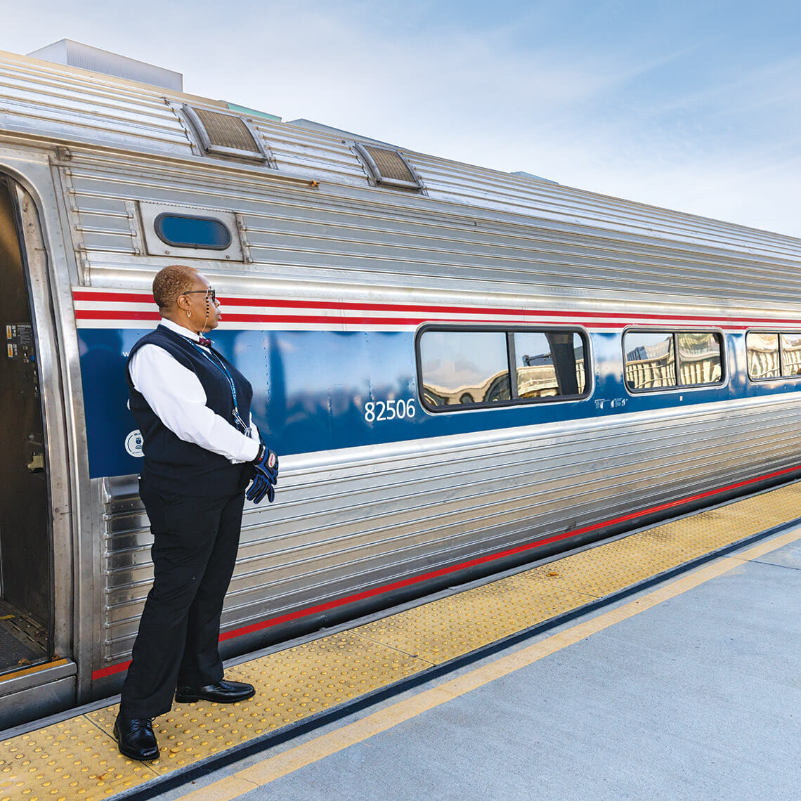 An Amtrak station attendant next to a train at Raleigh Union Station