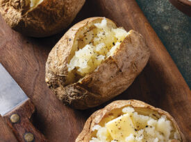 Baked potatoes topped with butter and black pepper