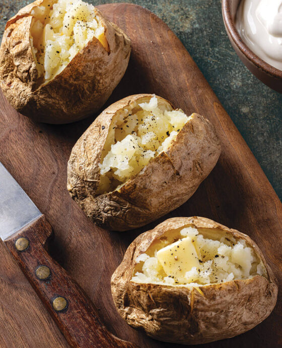 Baked potatoes topped with butter and black pepper