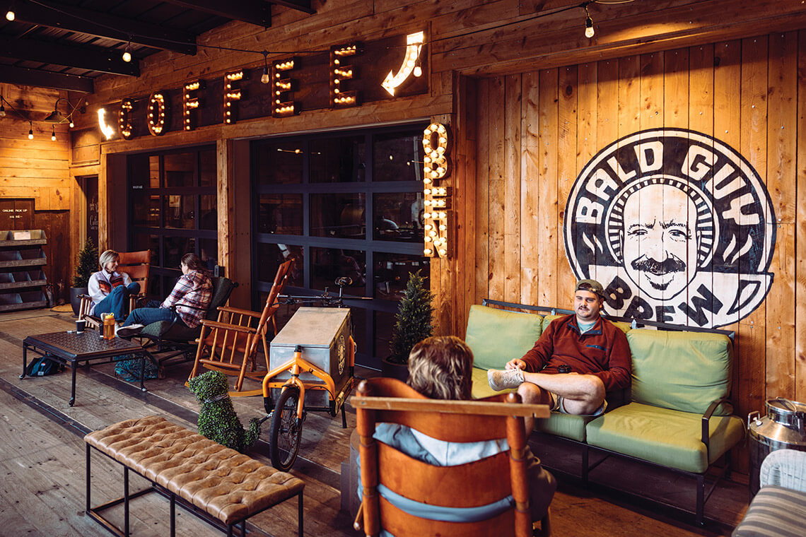 People on the porch at Bald Guy Brew