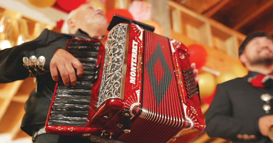 Father and son Cosme and Daniel Rangel perform at a quinceañero in Lincolnton