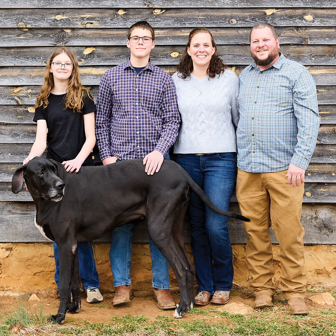 The Mitchell Family at their farm with their great dane.