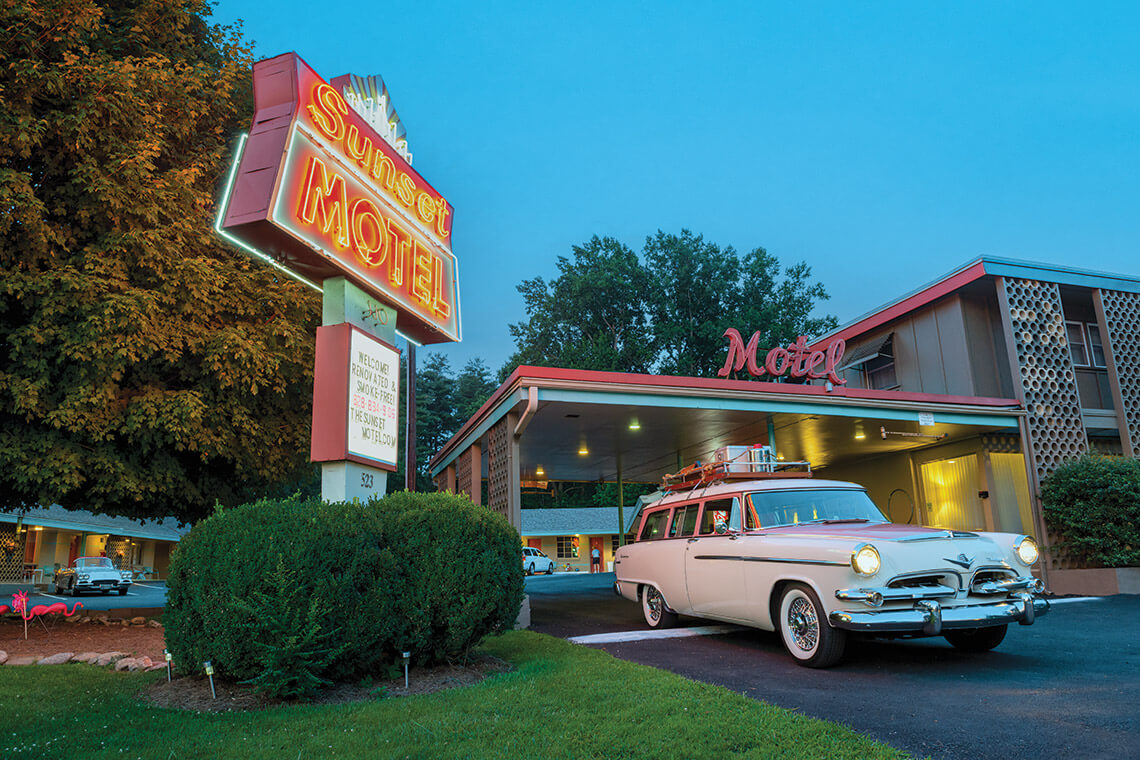 Exterior of the Sunset Motel with a vintage car
