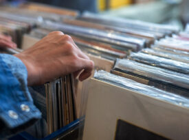 Hand thumbing through vinyl
