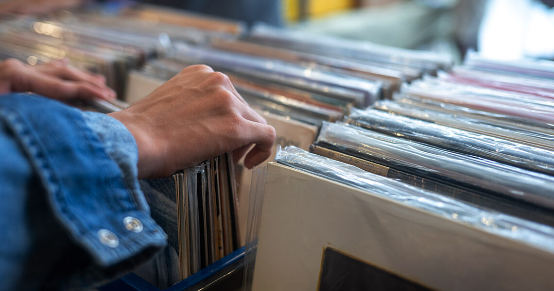Hand thumbing through vinyl