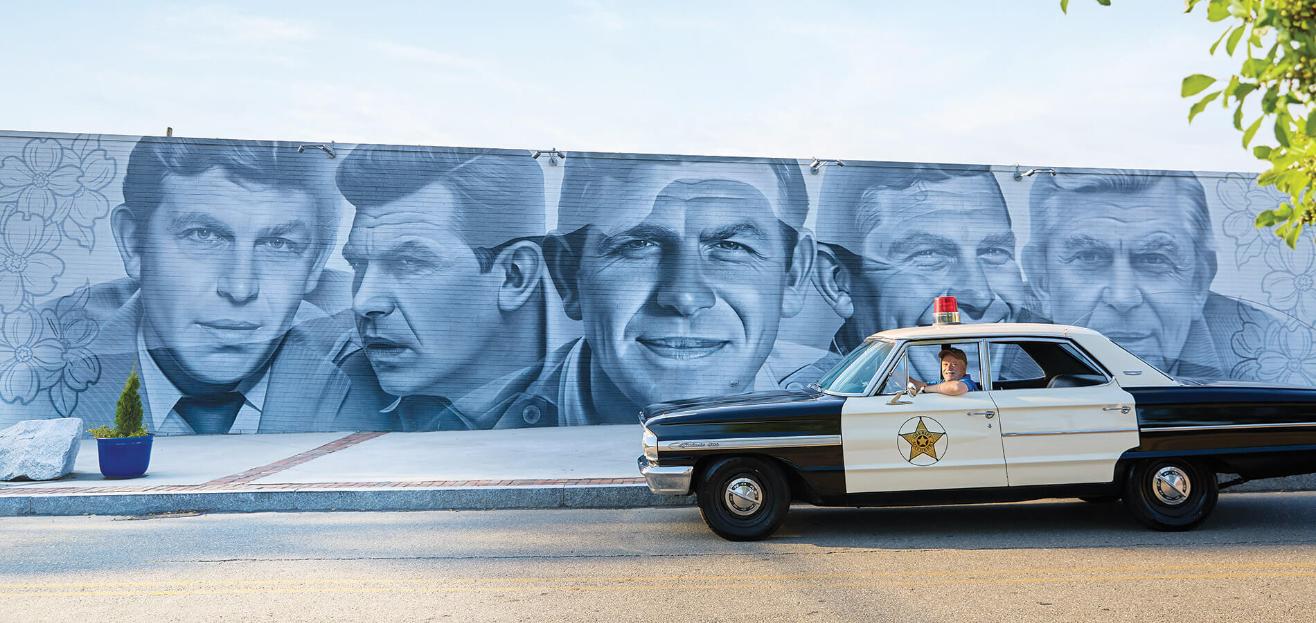 Vintage police squad car and Andy Griffith City mural in Mount Airy, NC