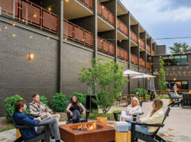 People sit outside at Rhodes Motor Lodge