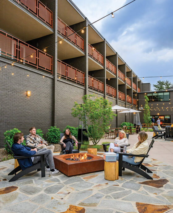 People sit outside at Rhodes Motor Lodge