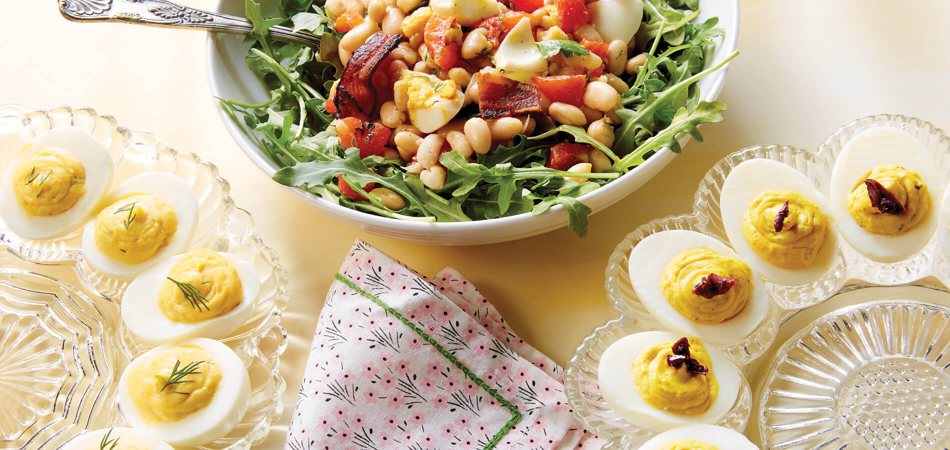 Spring table with egg and bean salad and two types of deviled eggs