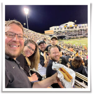 John Champlin with a hot dog at a Wake Forest game