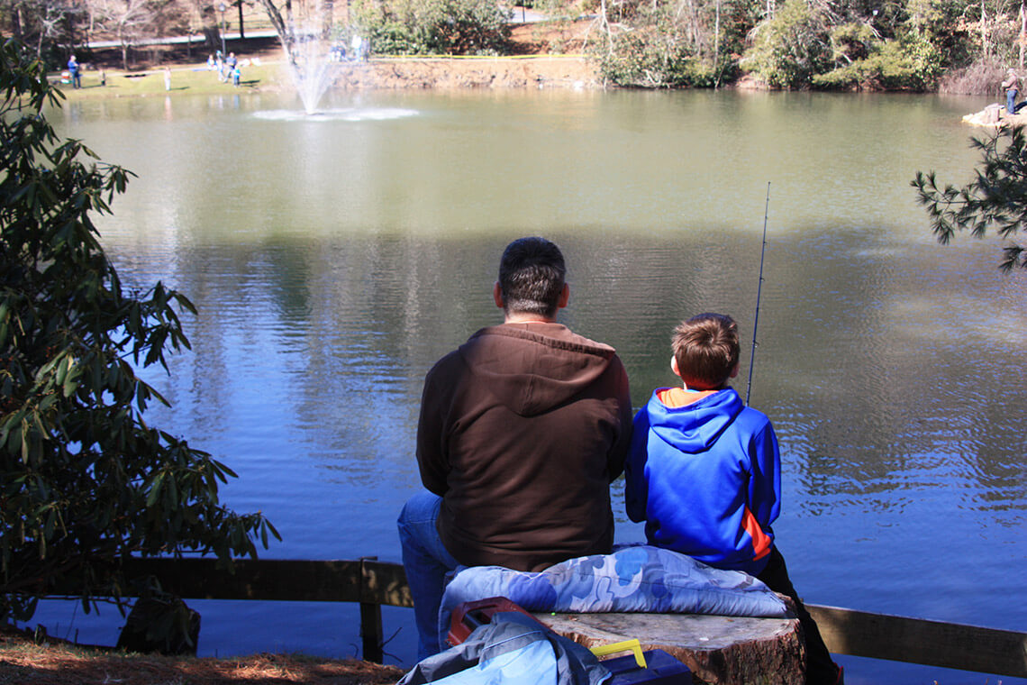 Man and child fishing at Mayview Lake in Blowing Rock