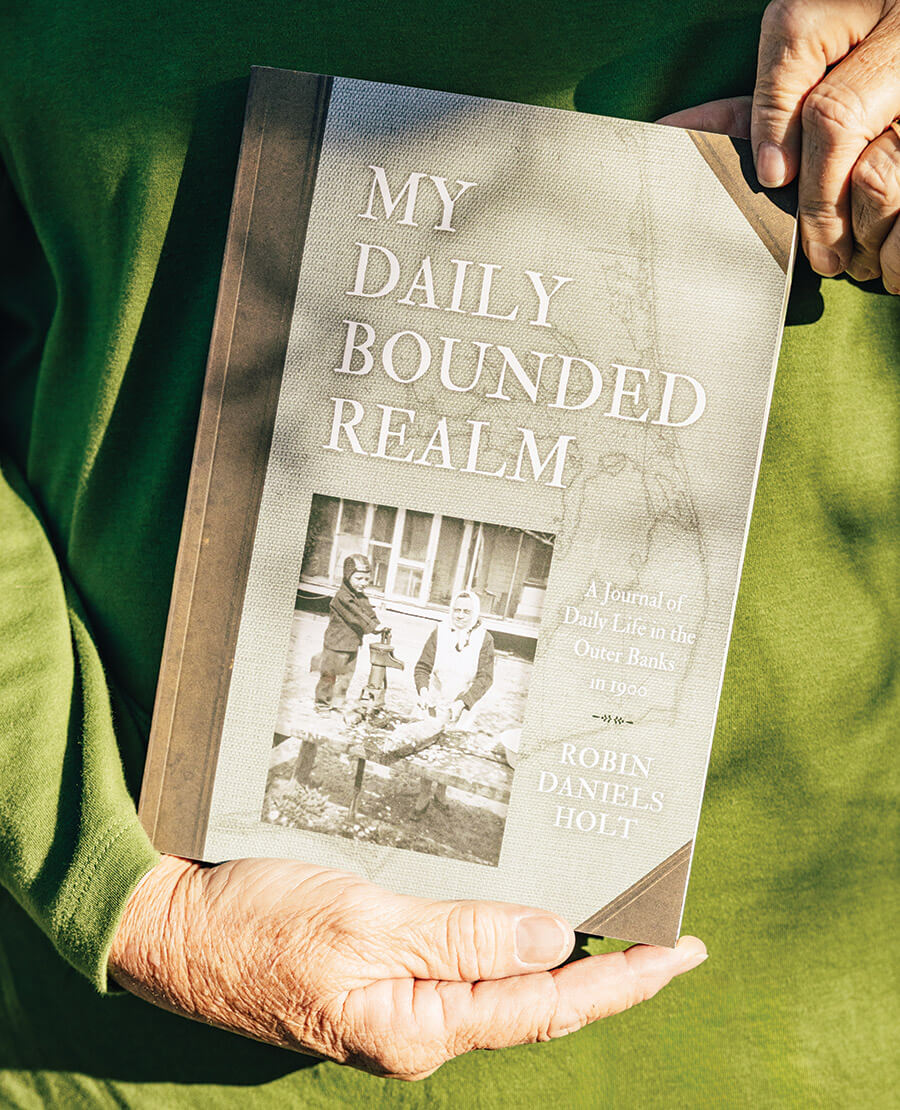 Holt holding a copy of her book, My Daily Bounded Realm.