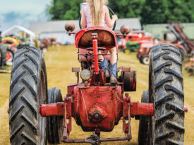 Child driving tractor at Southeast Old Threshers Reunion in Denton