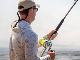 Active-duty service member fishing aboard the Triple S.