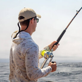 Active-duty service member fishing aboard the Triple S.