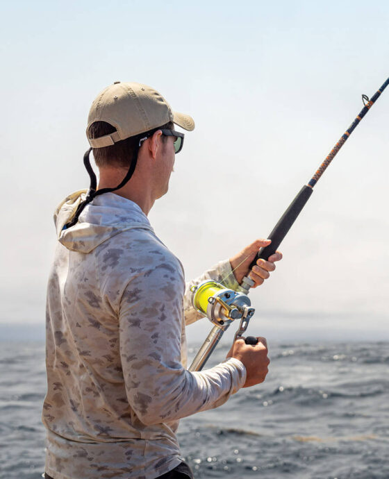 Active-duty service member fishing aboard the Triple S.